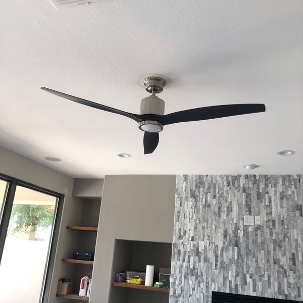 Modern three blade fan installed in living room.