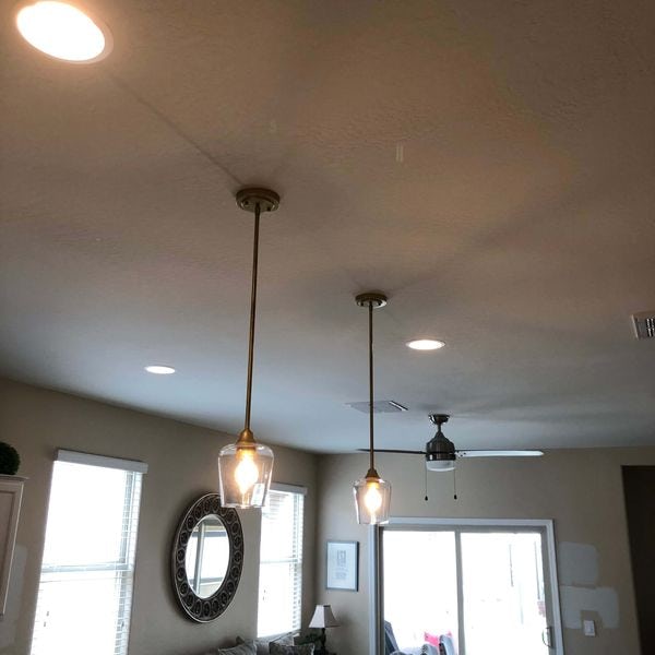 Pendant lighting installed above dining room table.