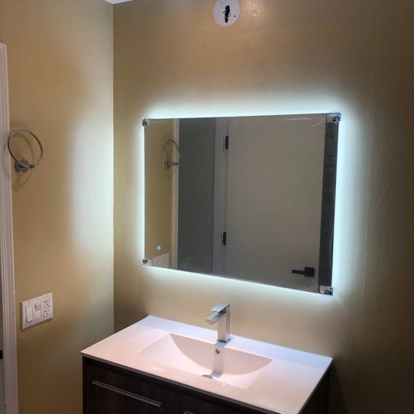 Lighting installed around bathroom mirror.