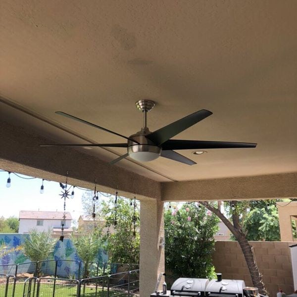 Modern ceiling fan installed under covered patio.