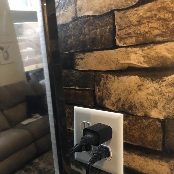 Outlet installed on tile wall in kitchen.