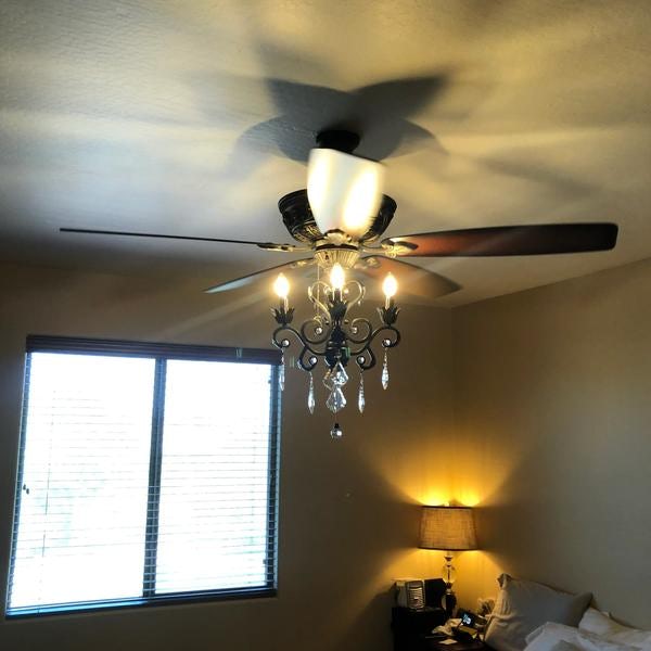 Ceiling fan with pull chains installed in bedroom.