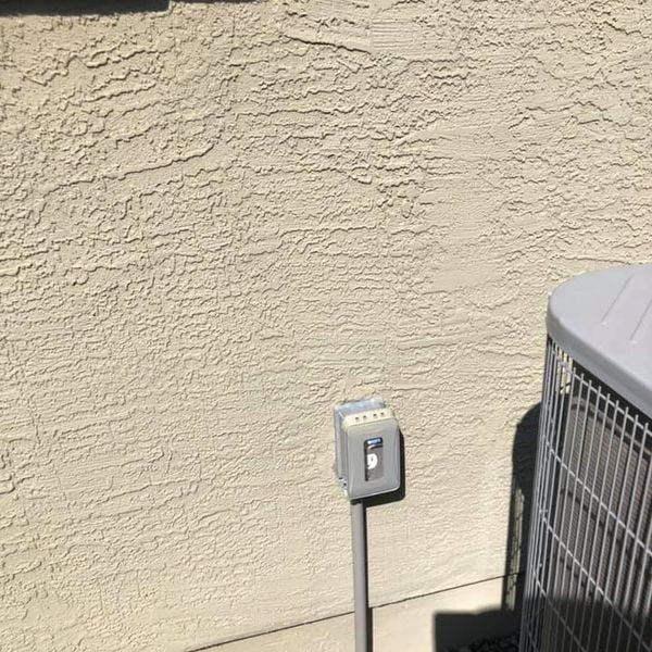 Outdoor outlet installed next to AC unit.